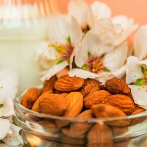Almond with jar of almond milk and white flowers