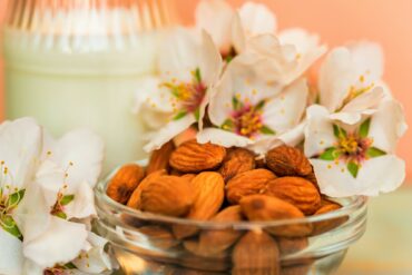 Almond with jar of almond milk and white flowers