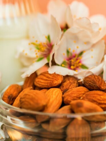 Almond with jar of almond milk and white flowers